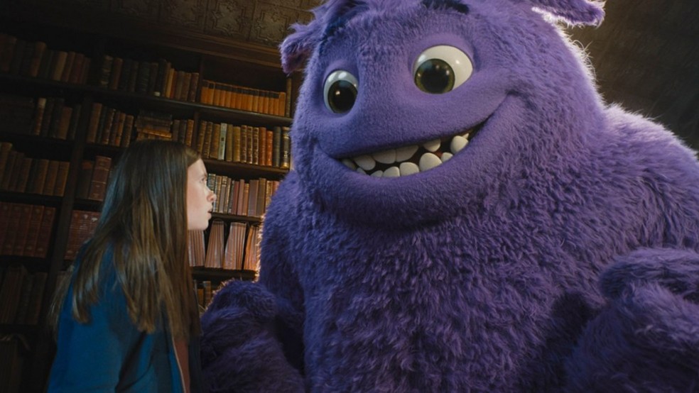 Still from the film IF (2024) A girl looks at a big furry purple creature.